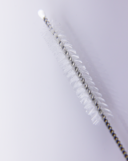 Close-up of a straw cleaning brush showing soft white bristles and twisted stainless steel wire for effective deep cleaning.