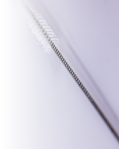 Macro view of the twisted wire handle and fine bristles of a straw cleaning brush, showing durable and precise construction.