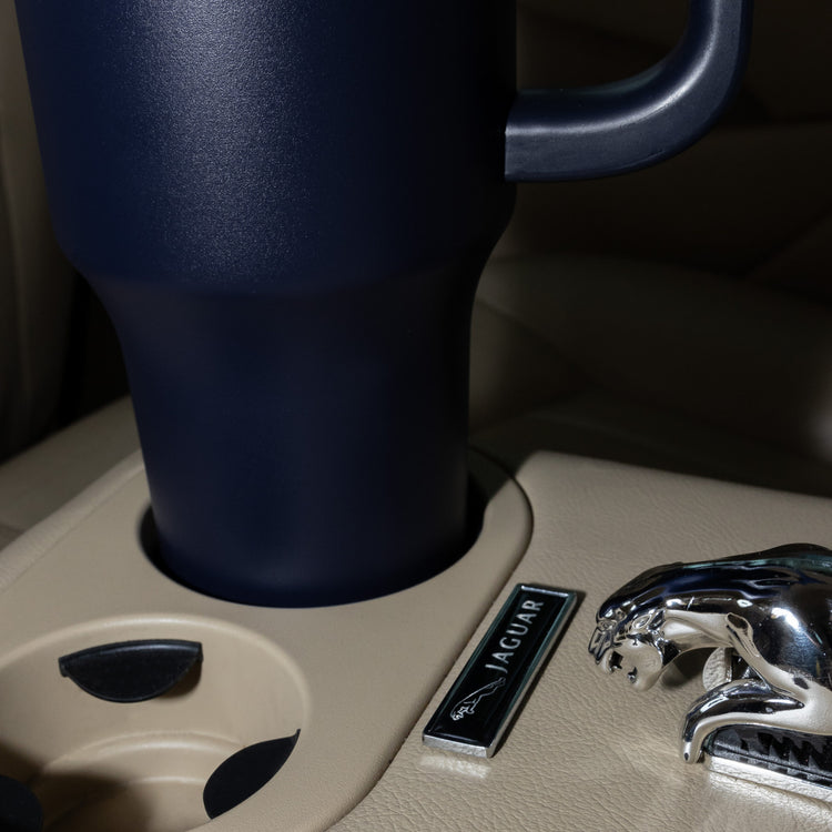 Whalecup tumbler in car cup holder next to Jaguar gear selector
